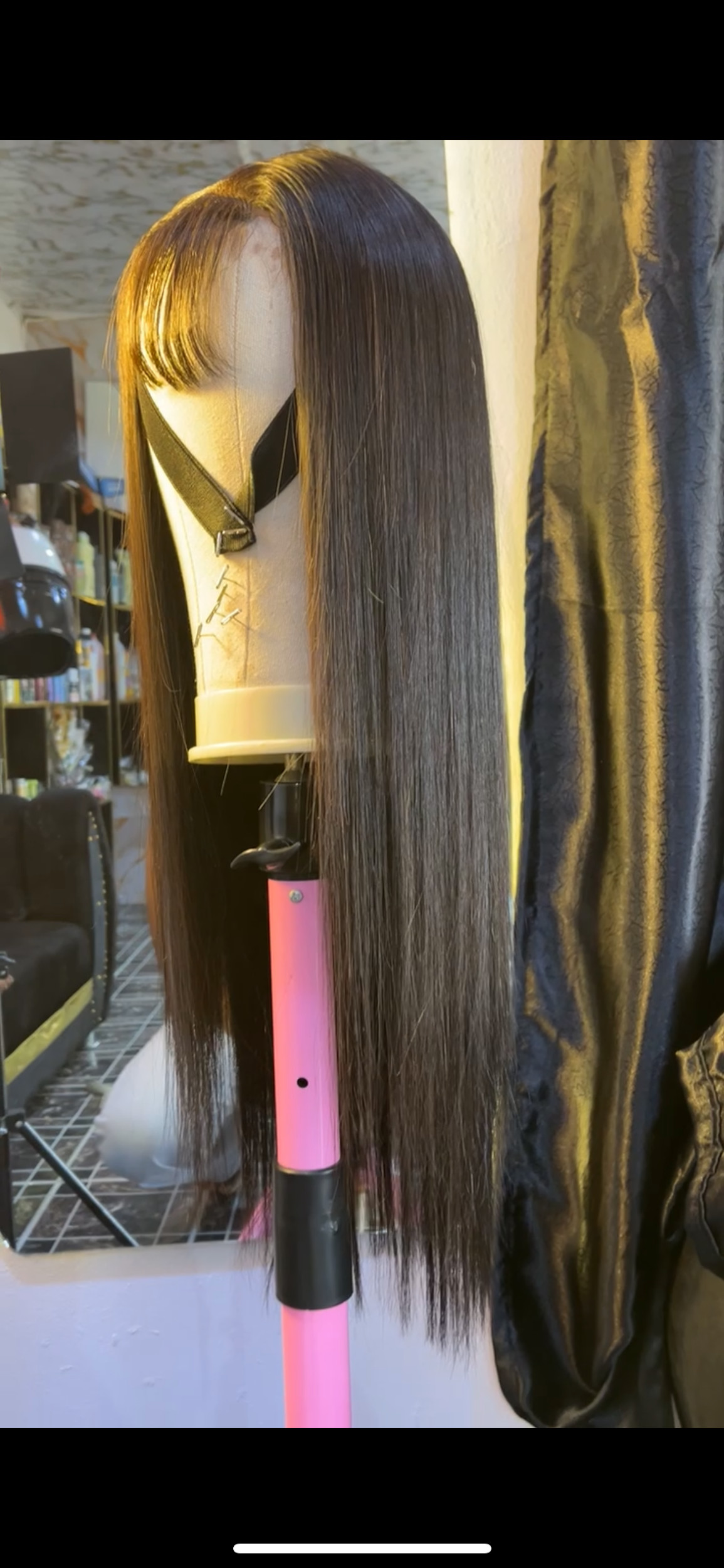 Long bone-straight wig with a fringe, styled on a stand