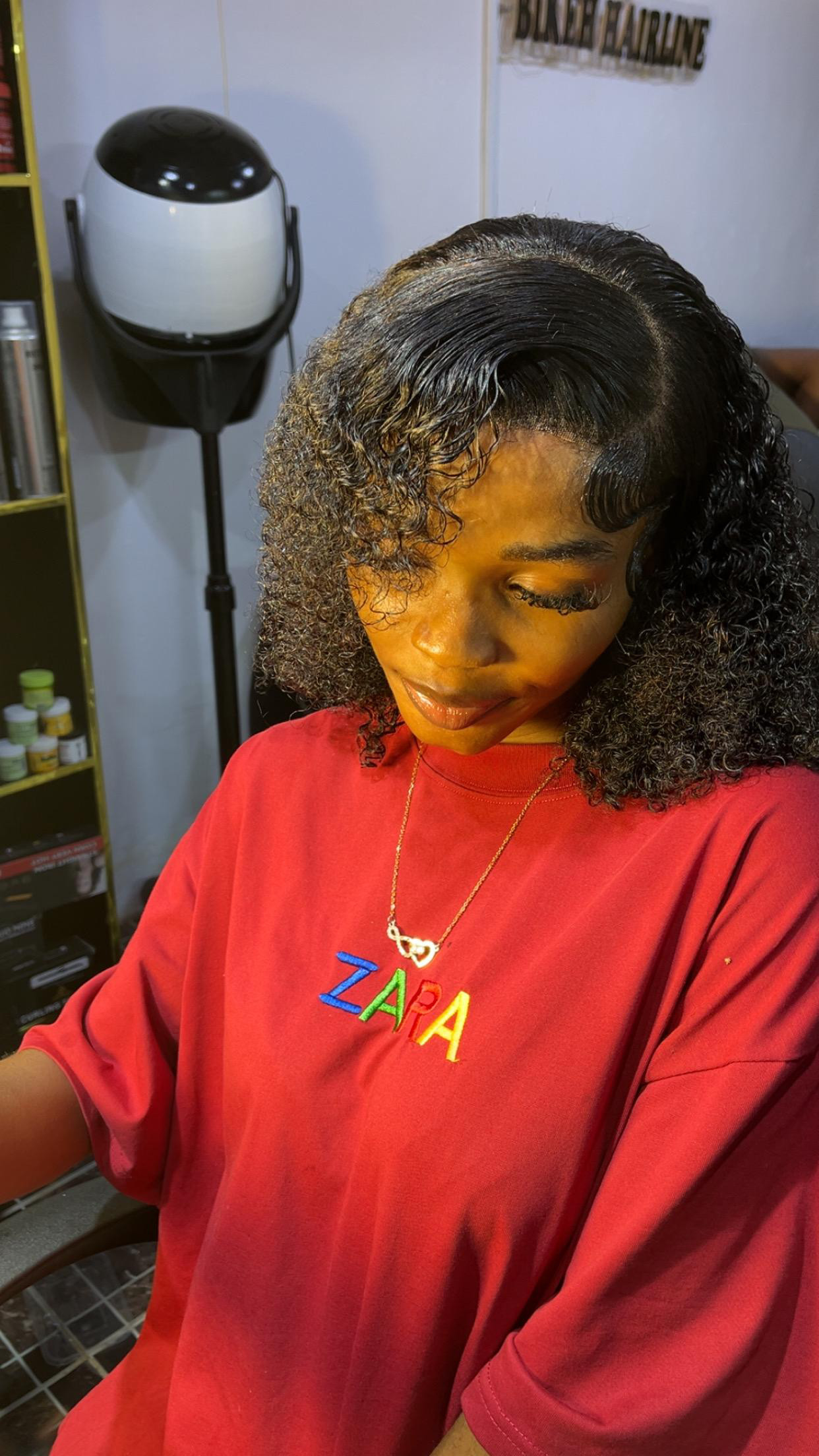Curly wig revamp styled with a deep side part and sculpted edges