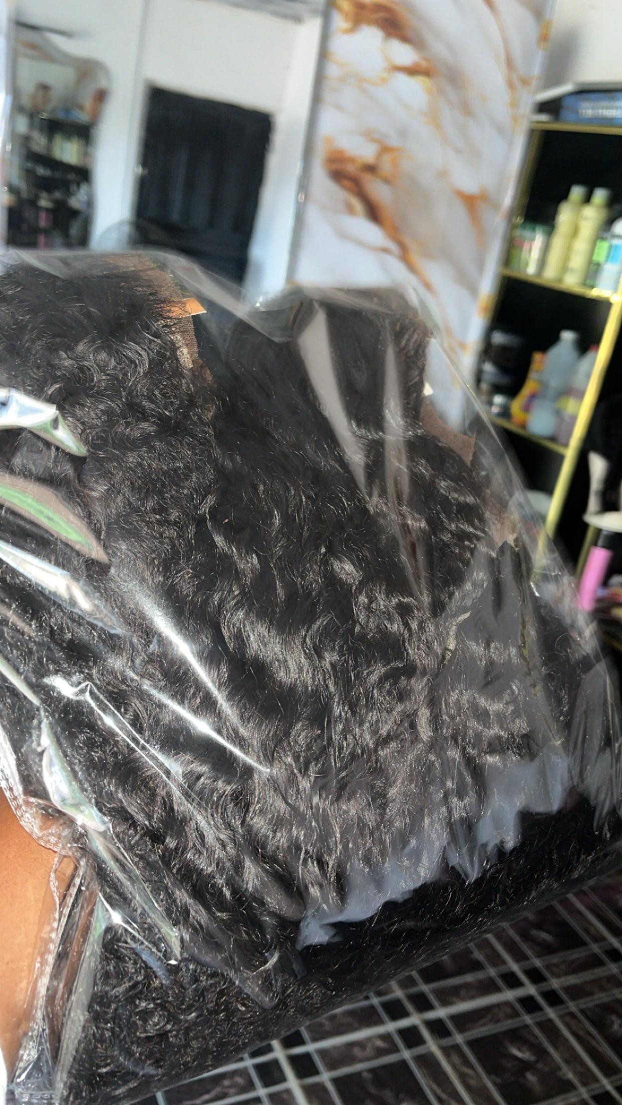 Sealed pack of premium curly hair bundles with frontals